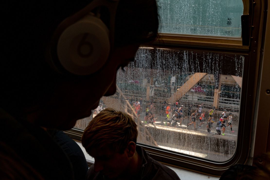 Runners are seen crossing the 59th Street Bridge from a subway train at the 2019 TCS New York City Marathon.