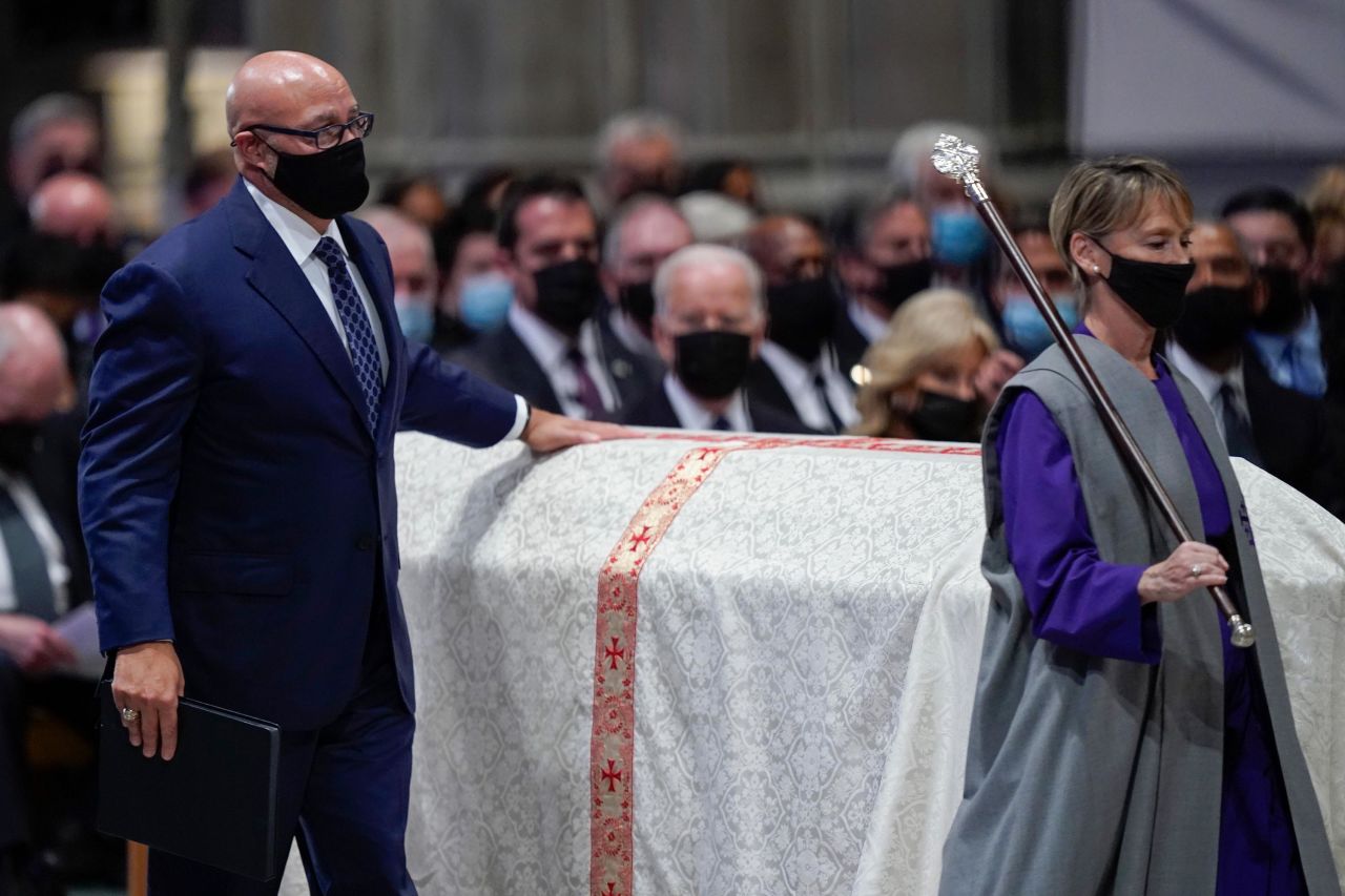 Michael Powell, Colin Powell's son, touches his father's casket as he walks up to the podium to give a eulogy. <a href="https://www.cnn.com/politics/live-news/colin-powell-funeral-services-11-05-21/h_b6ff19d6d575f2e3e706588043d80208" target="_blank">He painted a picture</a> of what his father was like at home. "Dad was famous for his 13 rules, but our family life was unregimented. No morning revelry or marching drills. It was a warm and joyous and loving home anchored by our strong and graceful mother Alma," he said.