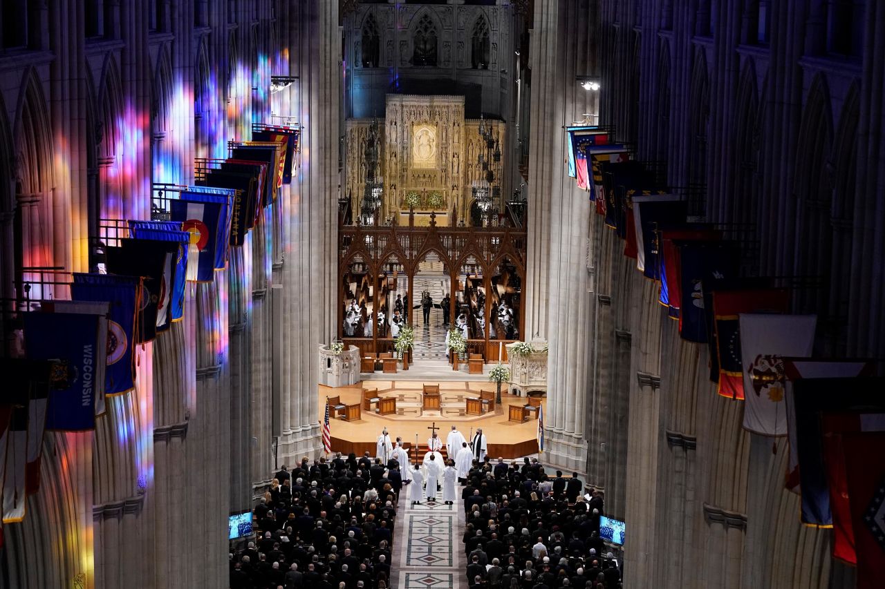 Clergy surround Powell's casket during the funeral.