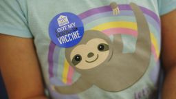 An 8 year-old child wears a sticker on her shirt after receiving the Pfizer COVID-19 vaccine for children ages 5-11 at a state-run site in Cranston, R.I., Thursday, Nov. 4, 2021.