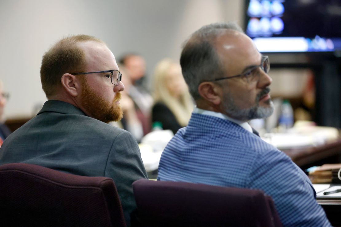 Travis McMichael, left, listens to opening statements with one of his attorneys on November 5, 2021 in Brunswick, Georgia.