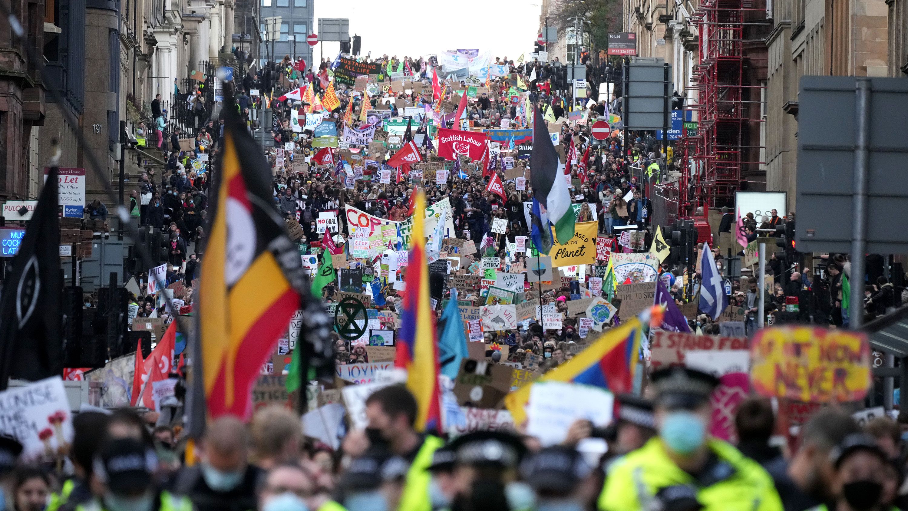 Demonstrators march through Glasgow on Friday to demand action on the cliamte crisis.