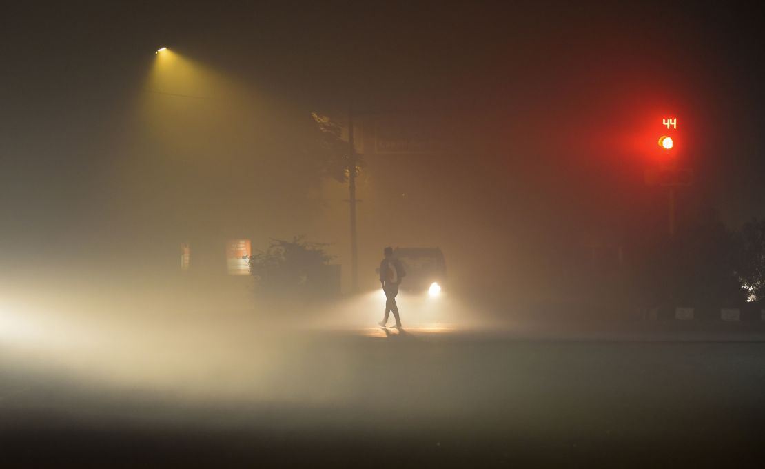 Vehicles drive in low visibility due to a thick layer of smog, on Diwali night on November 4 in New Delhi, India.