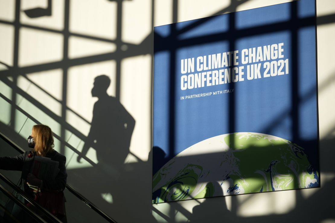 Delegates arrive at COP26 on Thursday. The day's theme was "Energy," and more than 20 countries agreed to end financing of fossil fuel projects abroad.