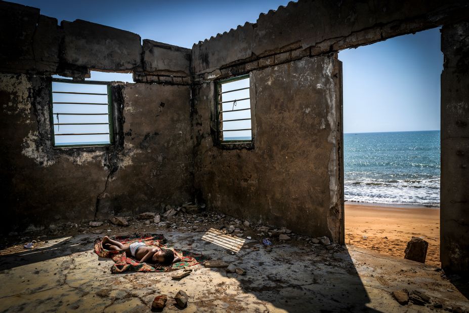 "The rising tide sons," Antonio Aragon Renuncio, 2019.<br /><br />The Environmental Photographer of the Year captured this image of a child sleeping inside a house destroyed by coastal erosion in Togo, West Africa.