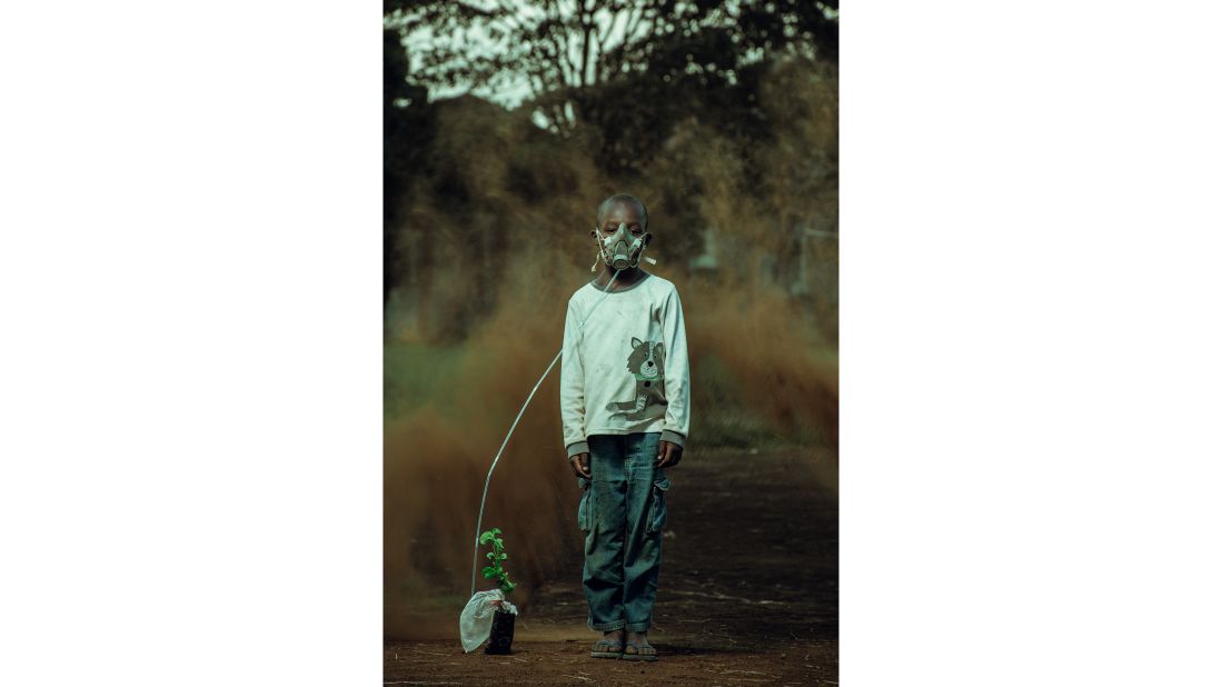 "The Last breath," Kevin Ochieng Onyango, 2021.<br />A boy breathes air from a plant as a storm brews behind him in this artistic impression of the coming changes in the Earth's climate. 