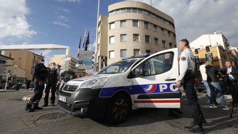 French police officers stand at a security perimeter following a knife attack in Cannes, France on Monday.