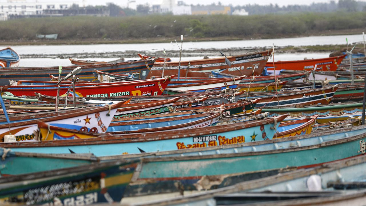 A photo taken on May 17, 2021 shows tied fishing boats for preparation against Cyclone Tauktae in India's western state of Gujarat. 