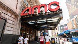 People walk outside AMC Empire 25 movie theater in Times Square on June 08, 2021 in New York City. 