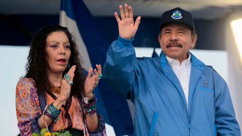 Nicaraguan President Daniel Ortega (R) waves to supporters, next to his wife and Vice President Rosario Murillo, during a march called ¬We walk for peace, with faith and hope¬ in honour of Salvadoran blessed Monsignor Oscar Arnulfo Romero, on the eve of his canonization, in Managua on October 13, 2018. (Photo by INTI OCON / AFP)        (Photo credit should read INTI OCON/AFP via Getty Images)