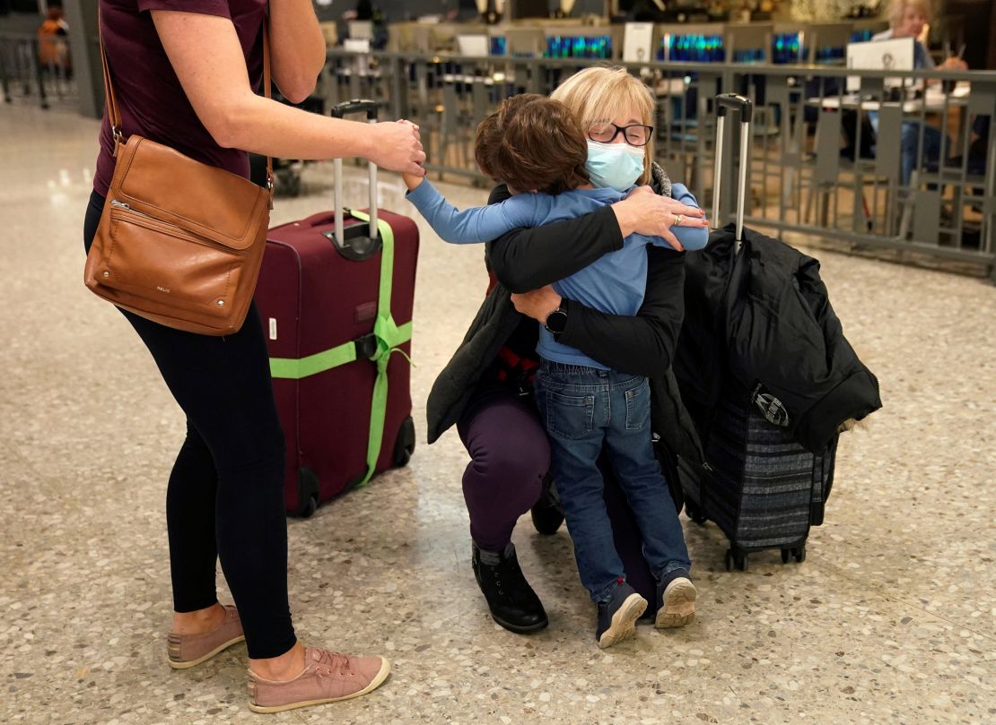 A woman arriving from Germany hugs a grandson she has not seen in three years at Dulles International Airport in Virginia on Monday.