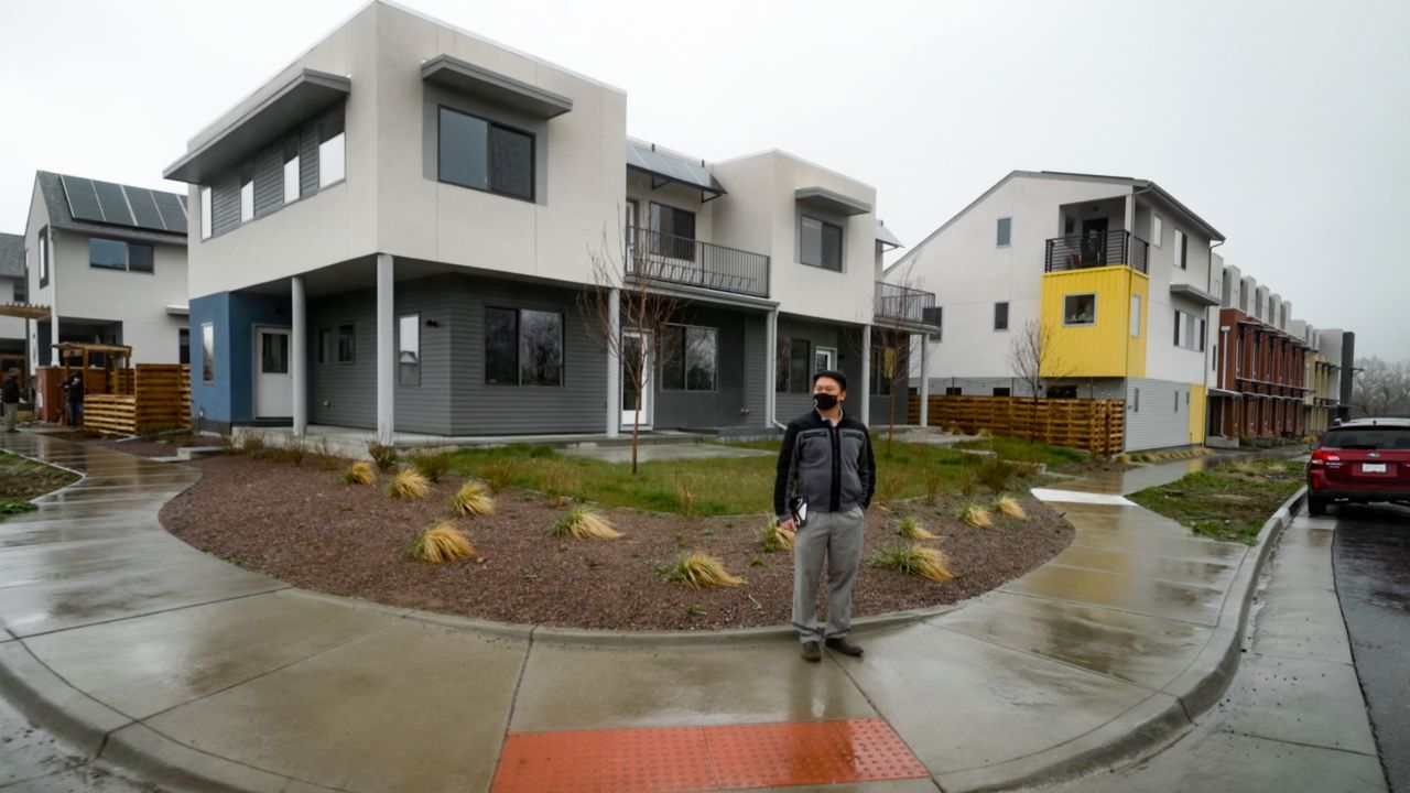 Dar-Lon Chang stands outside in his net-zero community of Geos in Arvada, Colorado. 