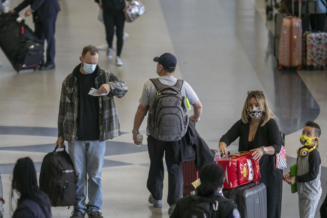 Holiday travelers pass through Los Angeles International Airport in November of 2020. Air travel is expected to be up 80% for Thanksgiving this year.