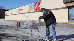 Dewey Minard pushes his cart to his car after shopping at the last standing Kmart store in Marshall, Michigan on Thursday, December 19, 2019. 