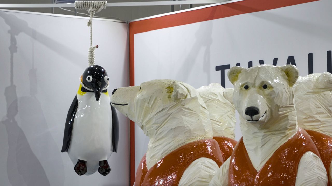 Tuvalu's booth at COP26 includes a sculpture by eco-artist Vincent Huang that features polar bears in life jackets and a penguin hanging by a noose.