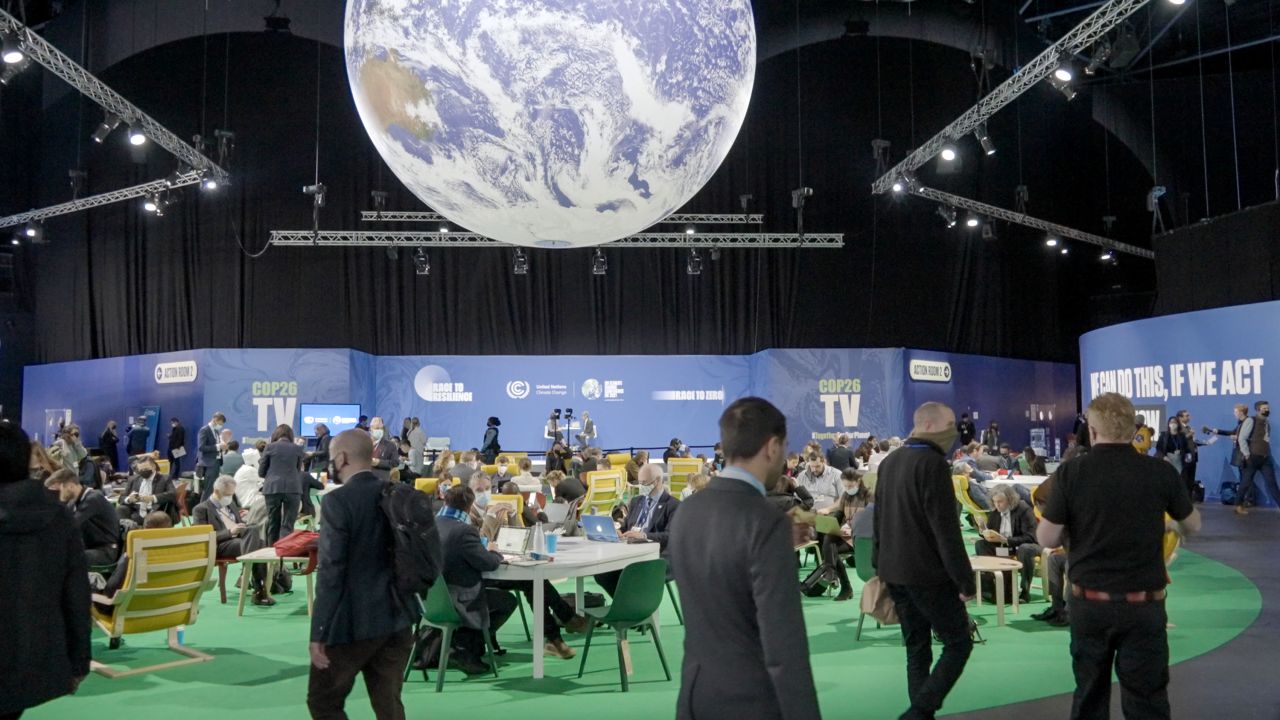 A giant globe spins over COP26 attendees at the OVO Hydro arena in Glasgow.