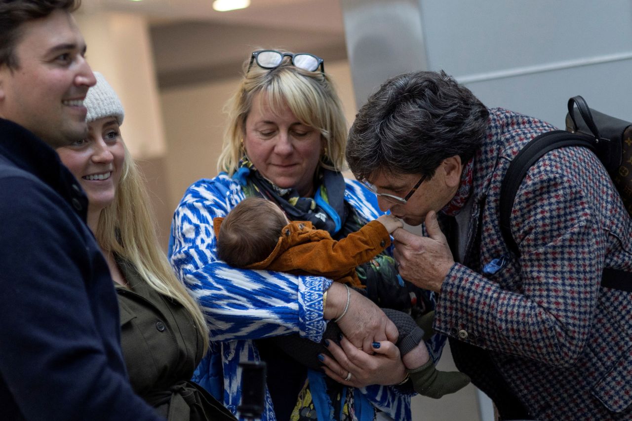 Jill and Stephen Brownbill react as they meet their young grandson, Rocco, at an international airport in New York on November 8.