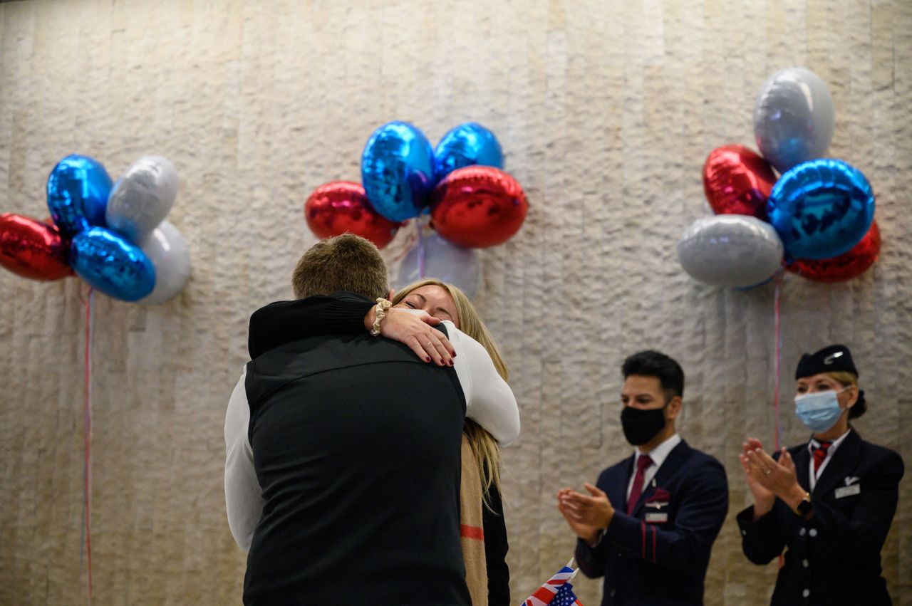 A couple embraces in New York after a flight arrived from the United Kingdom on November 8.
