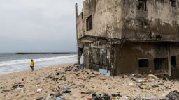 LAGOS, NIGERIA - OCTOBER 27, 2021: Delabitating buildings from the rising waters remain partially buried in sand along the beach. CREDIT: Yagazie Emezi for CNN.