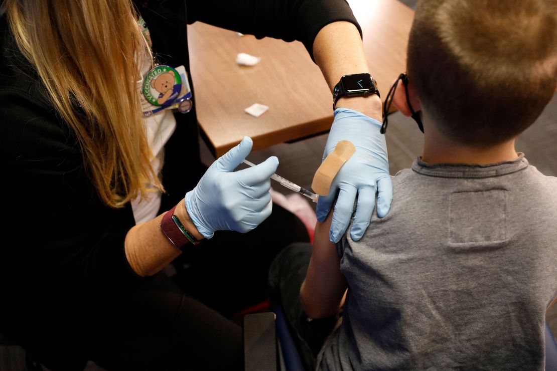 Kids receiving their first dose of the Covid-19 vaccine now will be partially protected by Thanksgiving. An 8-year-old receives the Pfizer-BioNTech vaccine in Southfield, Michigan, November 5.