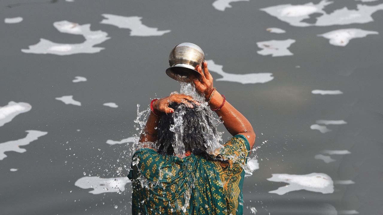 Devotees bathe on the eve of Chhatt Pooja in the toxic foam in the Yamuna River on November 9, 2021 in New Delhi, India.