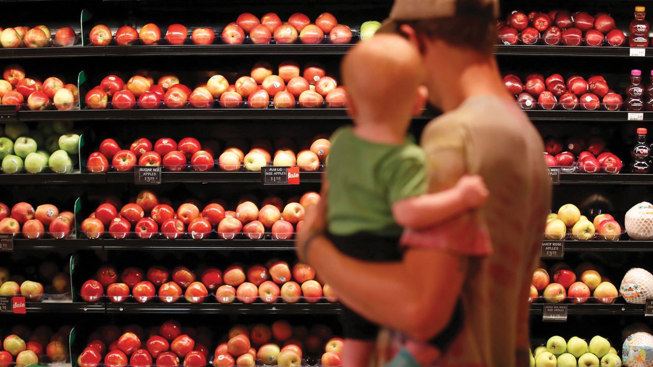 A customer views apples for sale at Harmons Grocery store in Salt Lake City, Utah, U.S., on Thursday, Oct. 21, 2021.