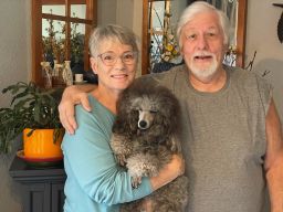 Sharon Henderson, shown with her husband, Paul, and dog, Dax, has started making her own burritos and casseroles to save money.