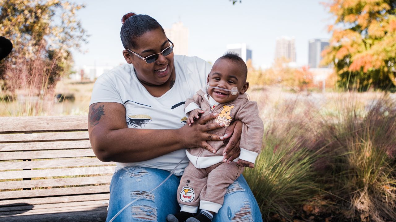 Michelle Butler holds Curtis, who is a lot healthier these days.