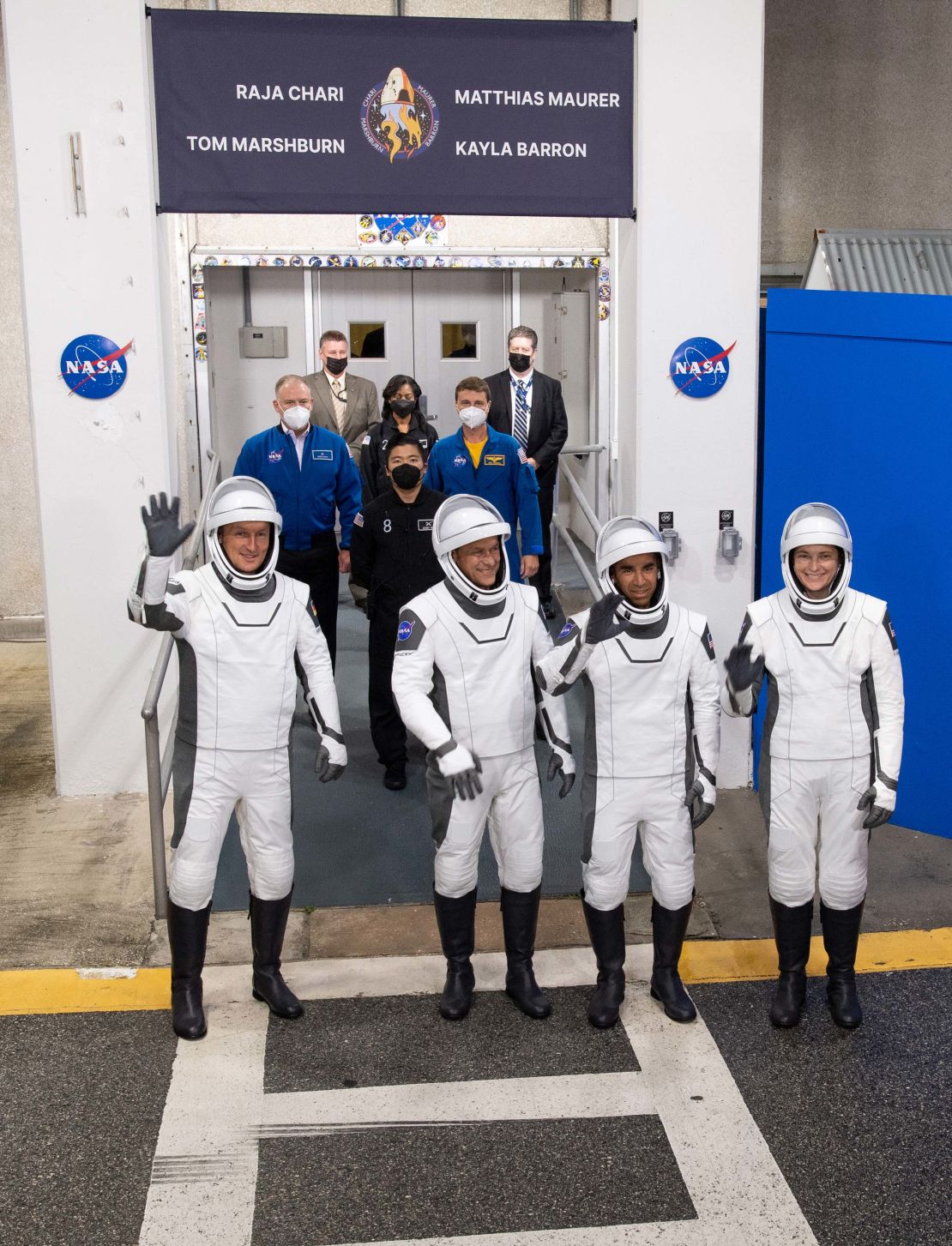 ESA (European Space Agency) astronaut Matthias Maurer, left, and NASA astronauts Tom Marshburn, second from left, Raja Chari, second from right, and Kayla Barron, right, wearing SpaceX spacesuits, are seen as they prepare to depart the Neil  A. Armstrong Operations and Checkout Building for Launch Complex 39A to board the SpaceX Crew Dragon spacecraft for the Crew-3 mission launch, Wednesday, Nov. 10, 2021, at NASA's Kennedy Space Center in Florida. NASA's SpaceX Crew-3 mission is the third crew rotation mission of the SpaceX Crew Dragon spacecraft and Falcon 9 rocket to the International Space Station as part of the agency's Commercial Crew Program. Chari, Marshburn, Barron, Maurer are scheduled to launch at 9:03 p.m. EST, from Launch Complex 39A at the Kennedy Space Center.  Photo Credit: (NASA/Joel Kowsky)