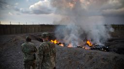 U.S. Army soldiers watch garbage burn in a burn-pit at Forward Operating Base Azzizulah in Maiwand District, Kandahar Province, Afghanistan, February 4, 2013. REUTERS/Andrew Burton (AFGHANISTAN - Tags: MILITARY)