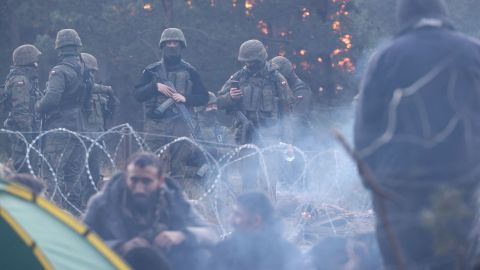 Migrants wait on the Belarusian side of the border on Wednesday. Thousands are facing desperate conditions as they try to cross into the EU.