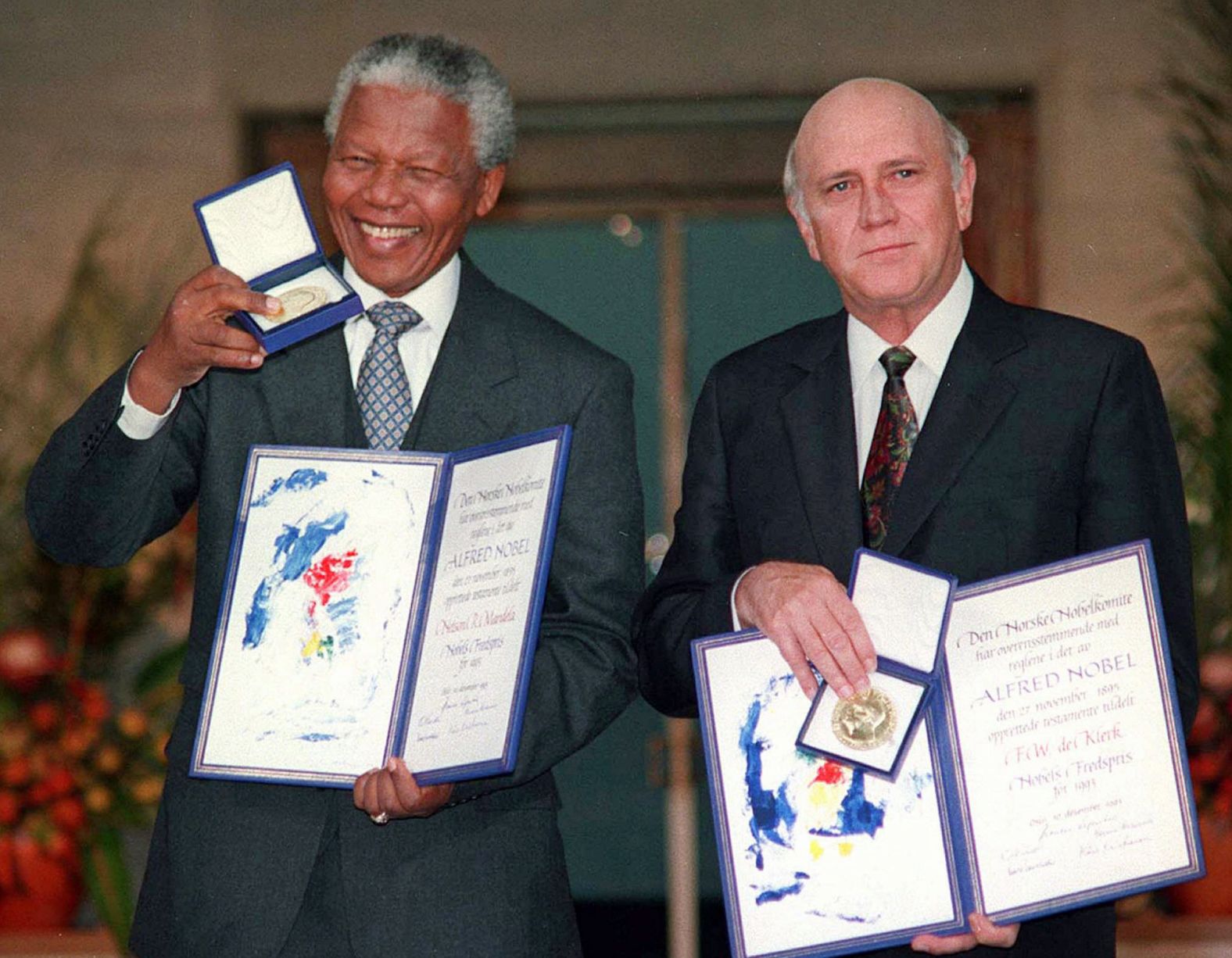South African President Mandela and Deputy President de Klerk pose with their Nobel Peace Prize medals on December 10, 1993, in Oslo, Norway.