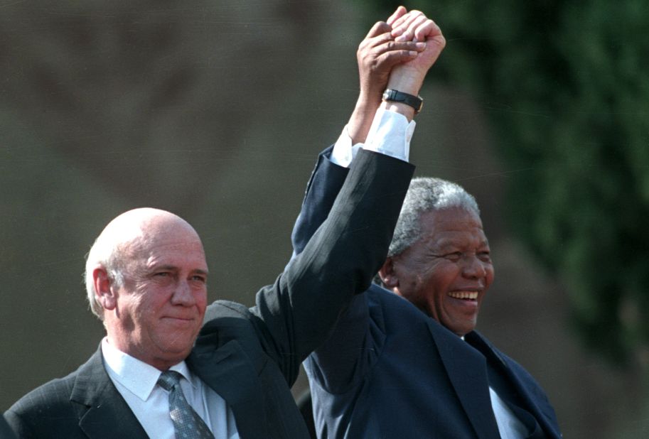 Mandela and de Klerk hold their hands high as they address a huge crowd on May 10, 1994, after the first presidential inauguration.