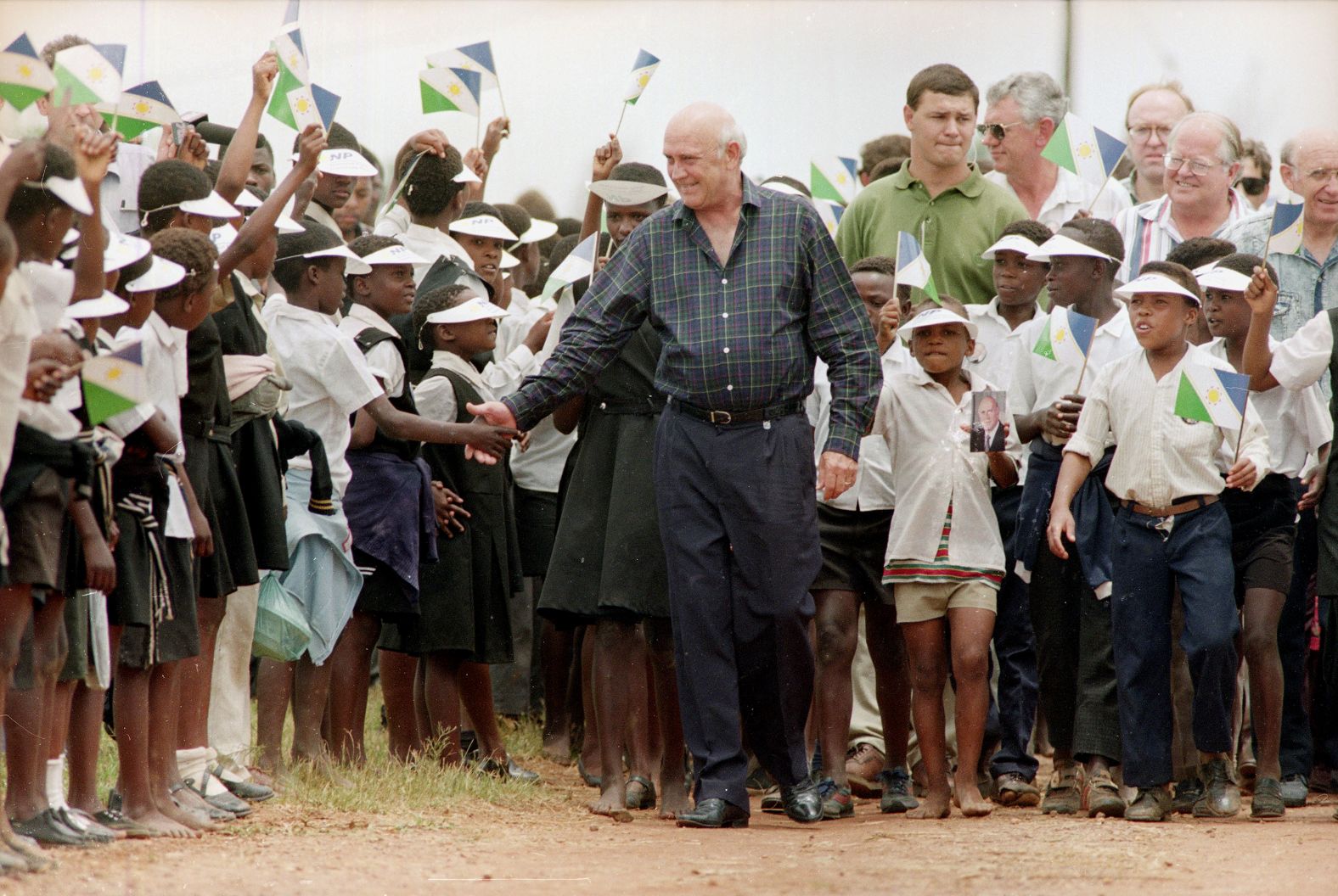 De Klerk shakes hands with schoolchildren before a campaign rally on January 21, 1994, with farm workers, farmers and children in Dwarsfontein, South Africa.