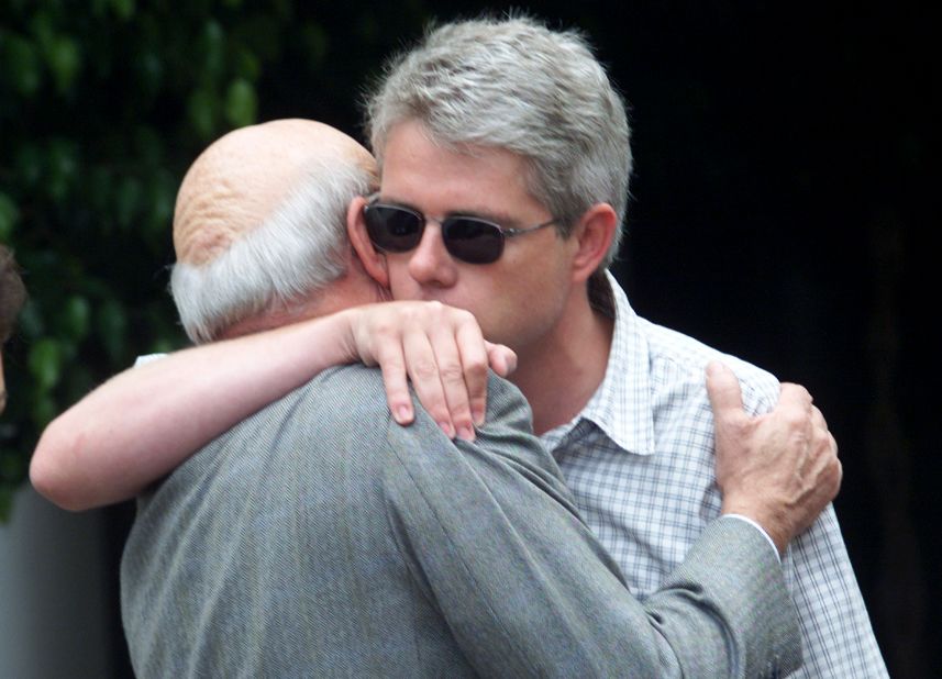 De Klerk hugs his son Willem as he arrives home in Cape Town on December 6, 2001, after De Klerk's wife Marike was murdered that week. A security guard was later convicted of her murder.