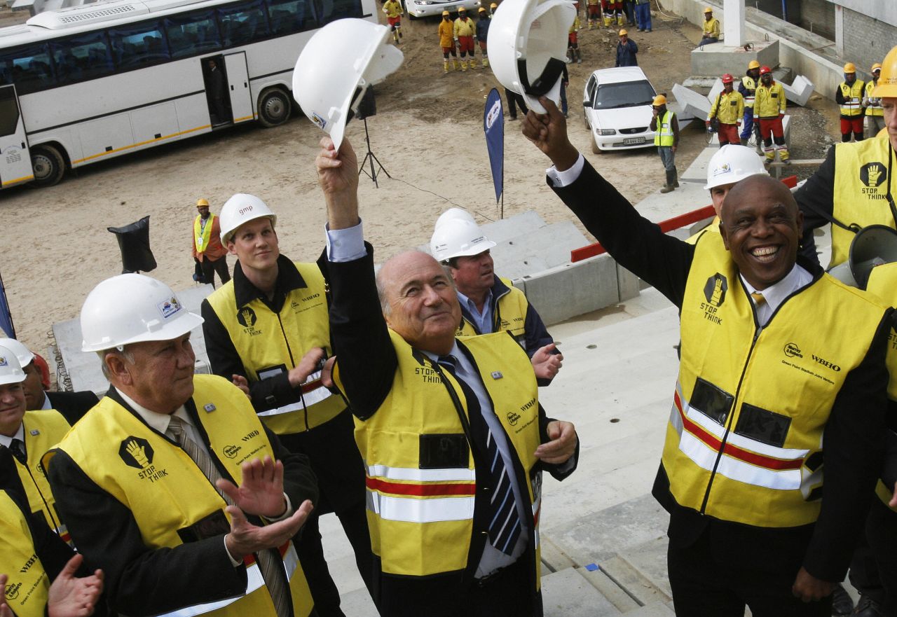 De Klerk, left, FIFA President Joseph Blatter, center, and South African businessman Tokyo Sexwale, right, greet construction workers at the Greenpoint 2010 World Cup football stadium on September 15, 2008, in Cape Town.