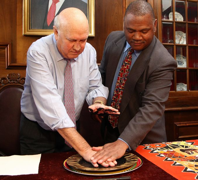 De Klerk and Cape Town Mayor Dan Plato attend a conference at which de Klerk adds his handprints to the Mandela Legacy Canvas at the Cape Town City Hall on July 7, 2010. 