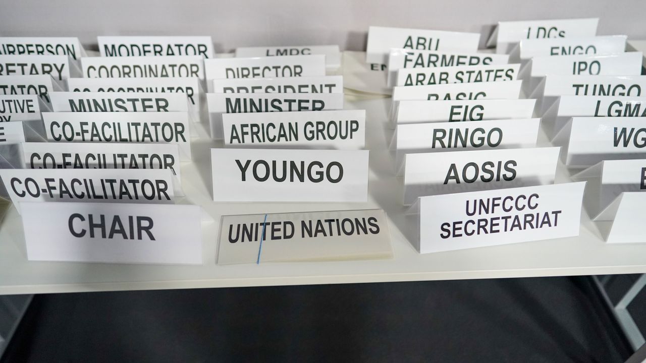 Department and position name plates are laid out ahead of a meeting at the COP26 climate summit.