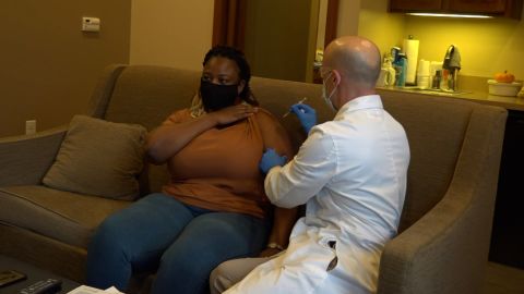 With tears in her eyes, Lorraine Charinda receives her second Covid vaccine on Wednesday.