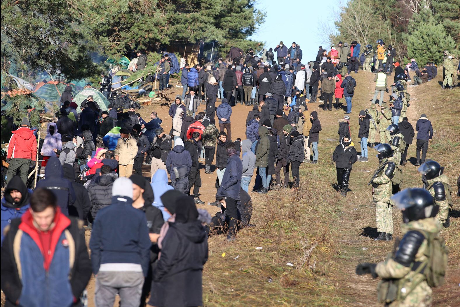 Migrants gather near the border on Monday, November 8.