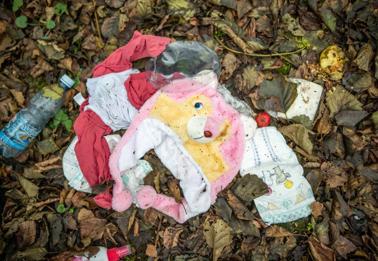 A child's cap, diapers and clothing lie in an abandoned migrant camp on Thursday, November 11.