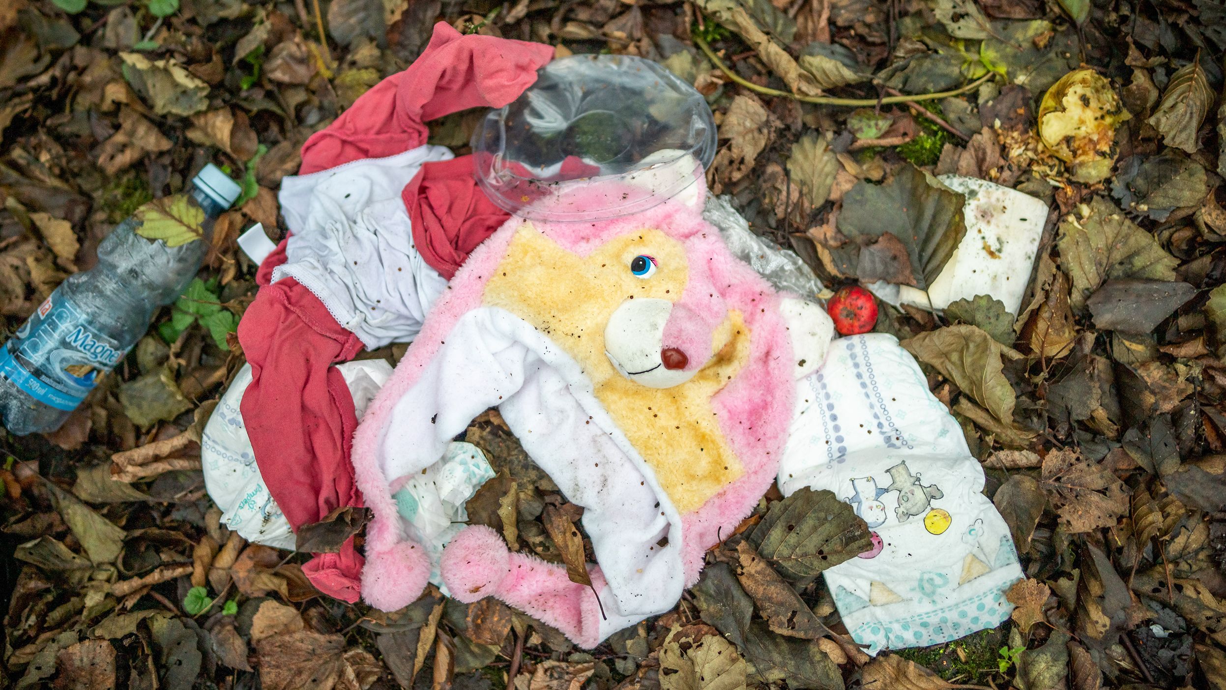 A child's cap, diapers and clothing lie in an abandoned migrant camp on Thursday, November 11.