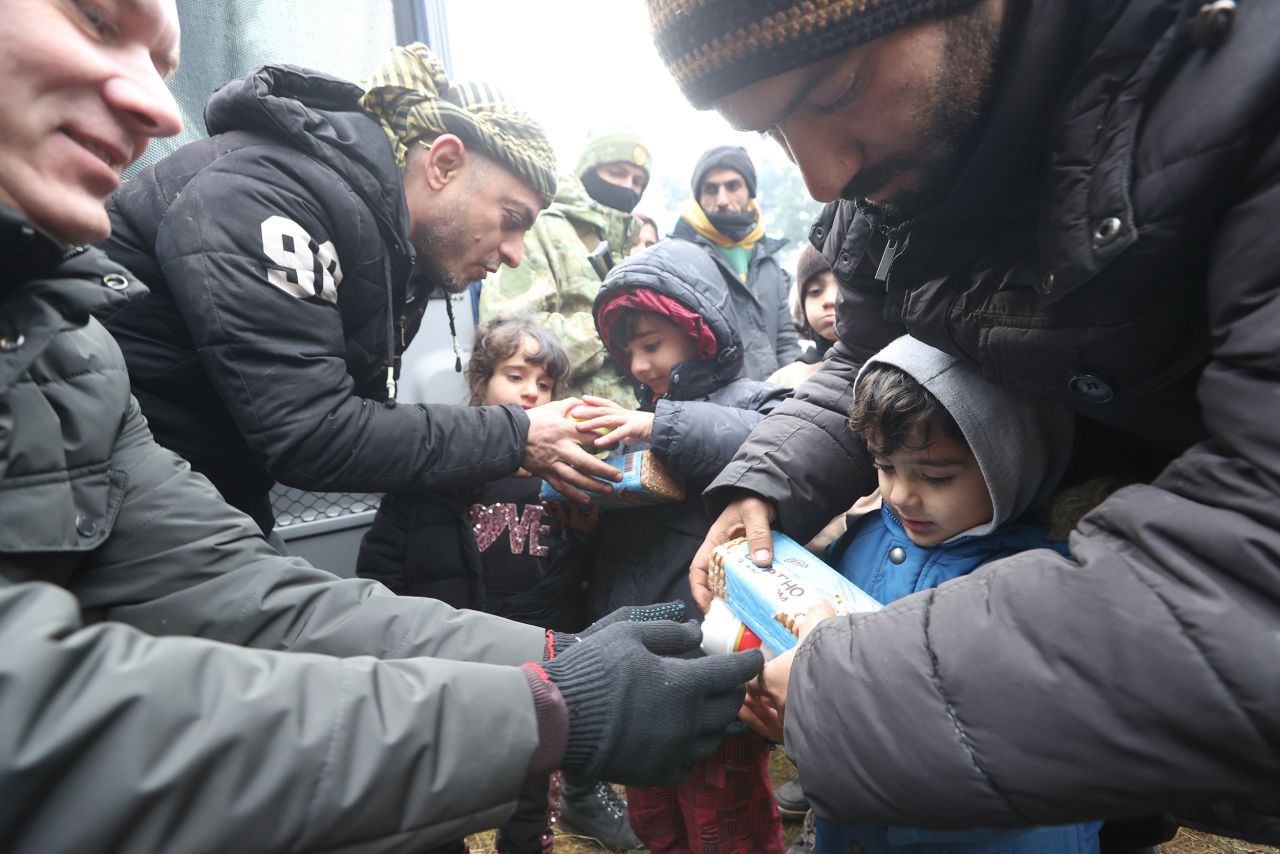 Migrants receive food and water on Wednesday, November 10.