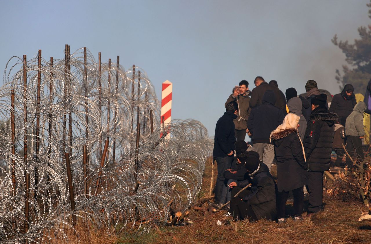 Migrants walk near the Polish border on Monday, November 8.