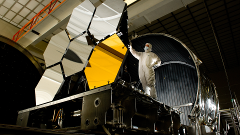 The lead optical test engineer inspects six primary mirror segments, critical elements of NASA's James Webb Space Telescope.