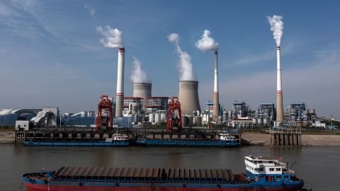Ships carrying coal unload outside a power plant on November 11, 2021 in Hanchuan, Hubei province, China.