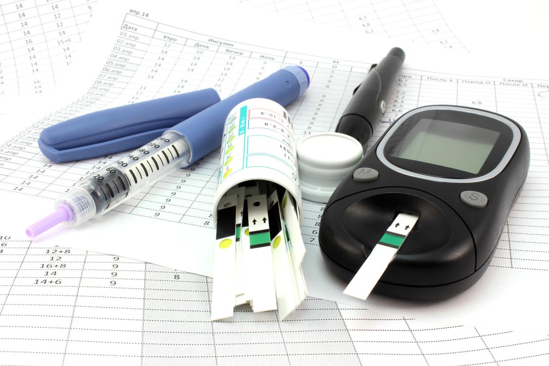 A typical glucometer, test strips, and insulin syringe used to manage diabetes.