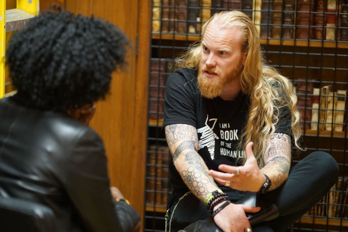 A woman listens to a Satanist explain his beliefs at a Human Library event.