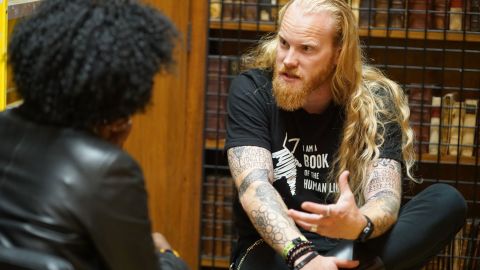 A woman listens to a Satanist explain his beliefs at a Human Library event. 