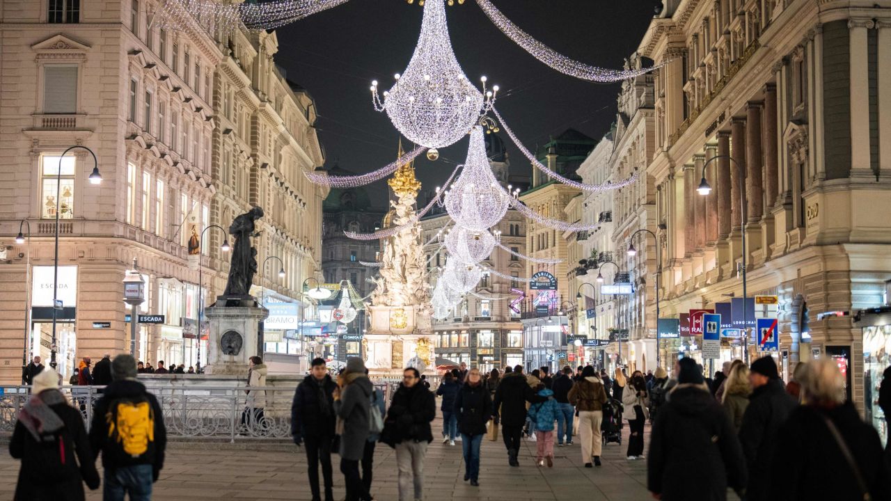 People walk among Christmas lights on November 12, 2021, near Stephanplatz in Vienna, Austria.